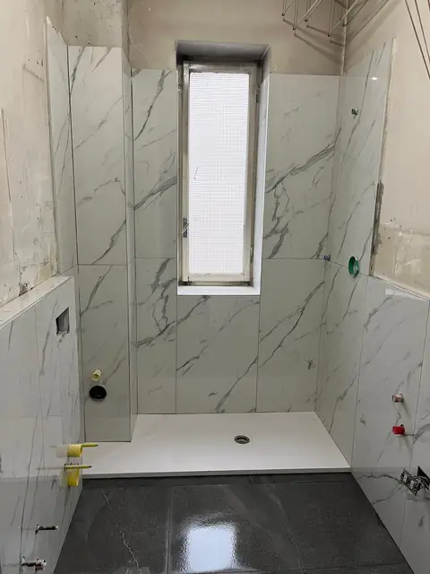 Bagno rifatto con rivestimento effetto marmo